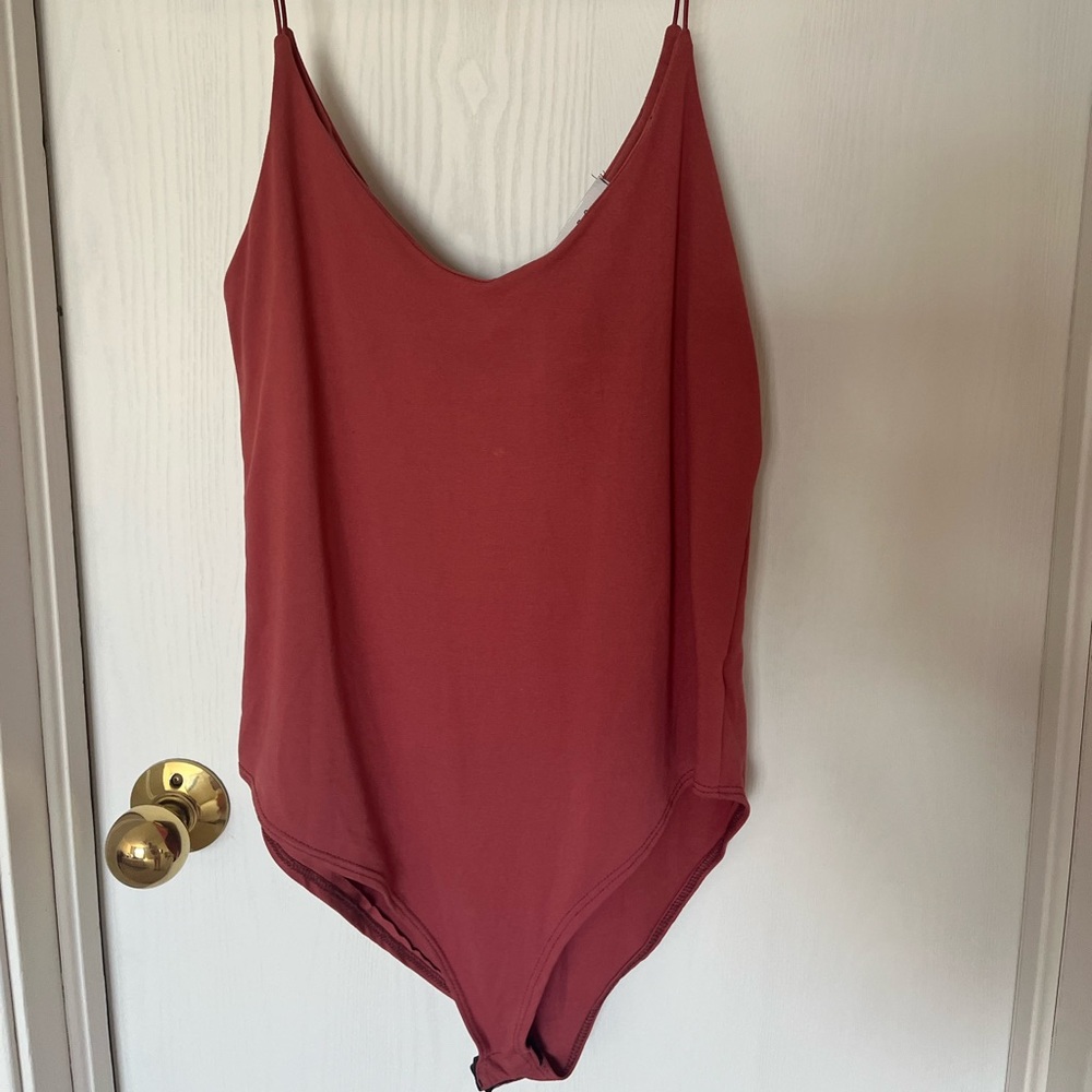 Gaze body suit, scoop neck with spaghetti straps and built in bra! Super cozy!